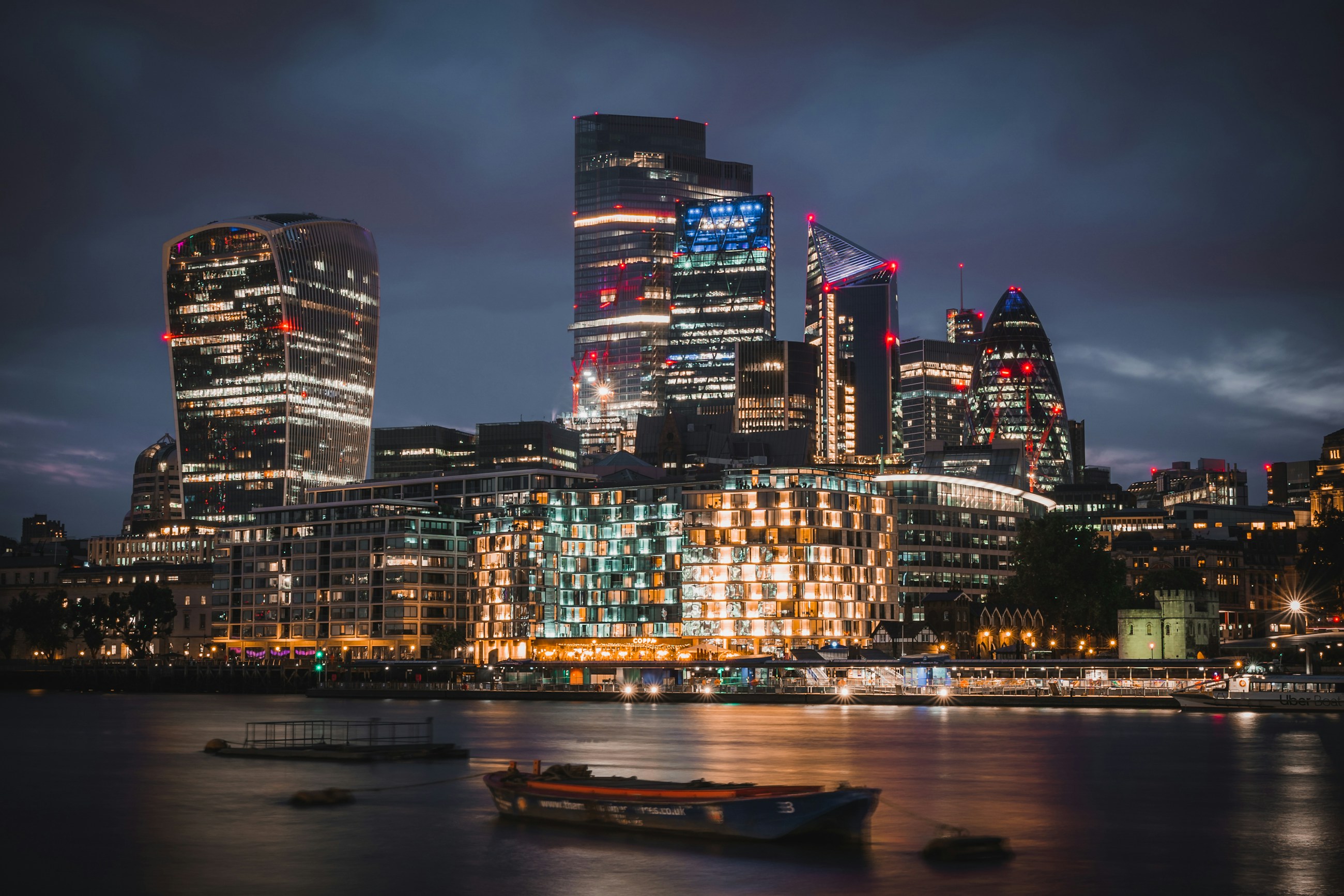 The London skyline at dusk over the River Thames.